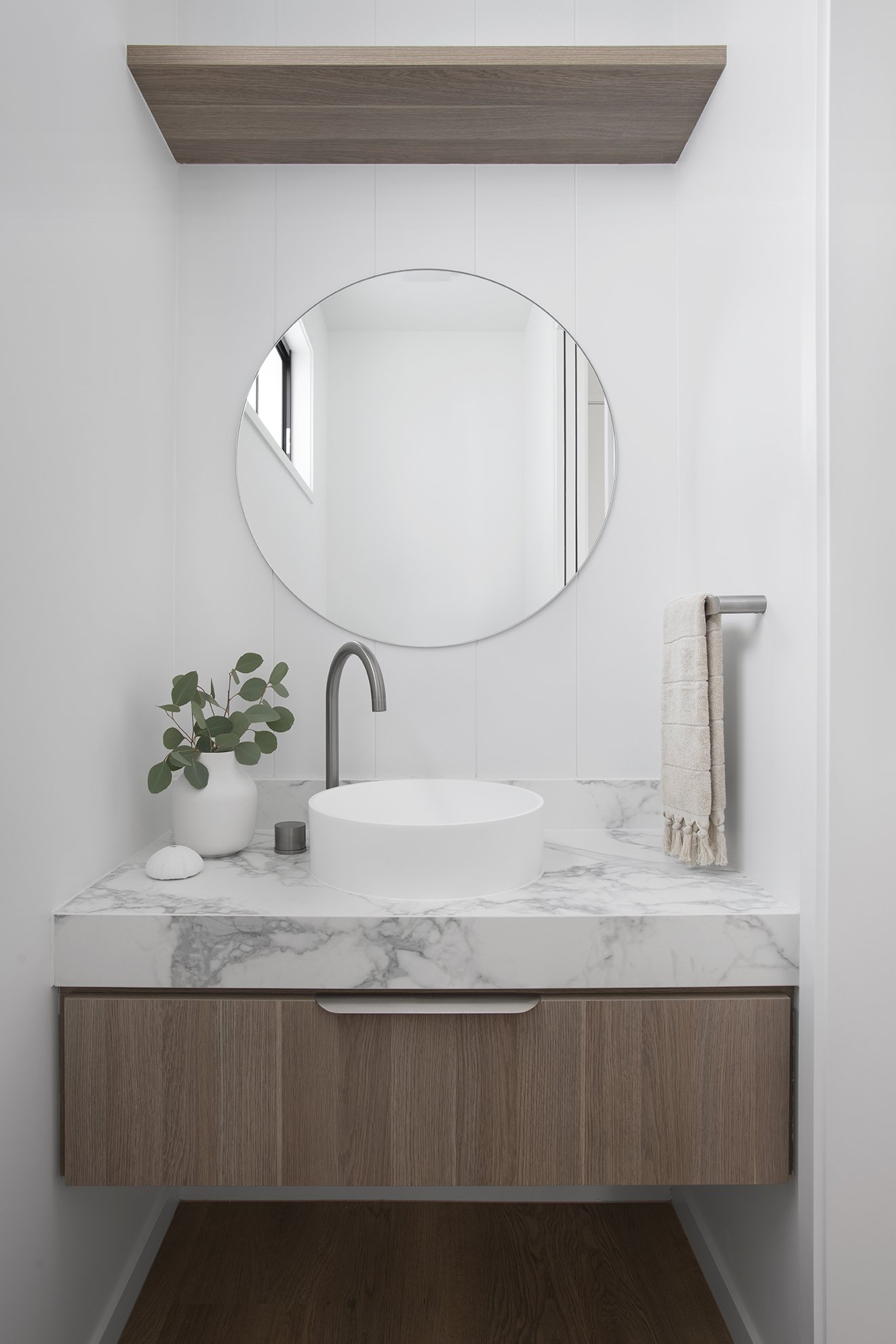 Round bathroom vanity mirror with small round sink basin in retreat house design bundle for home remodel
