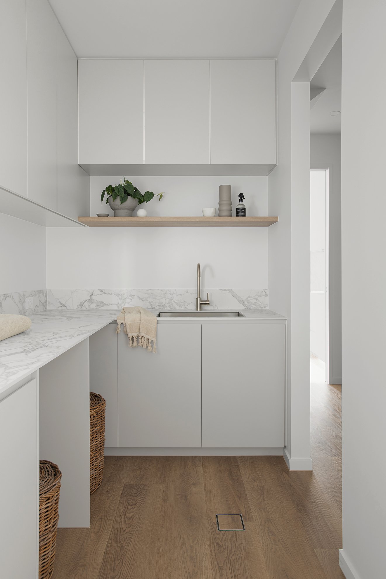 White counter and cabinets with a shelf in laundry design bundle for laundry renovation Adelaide
