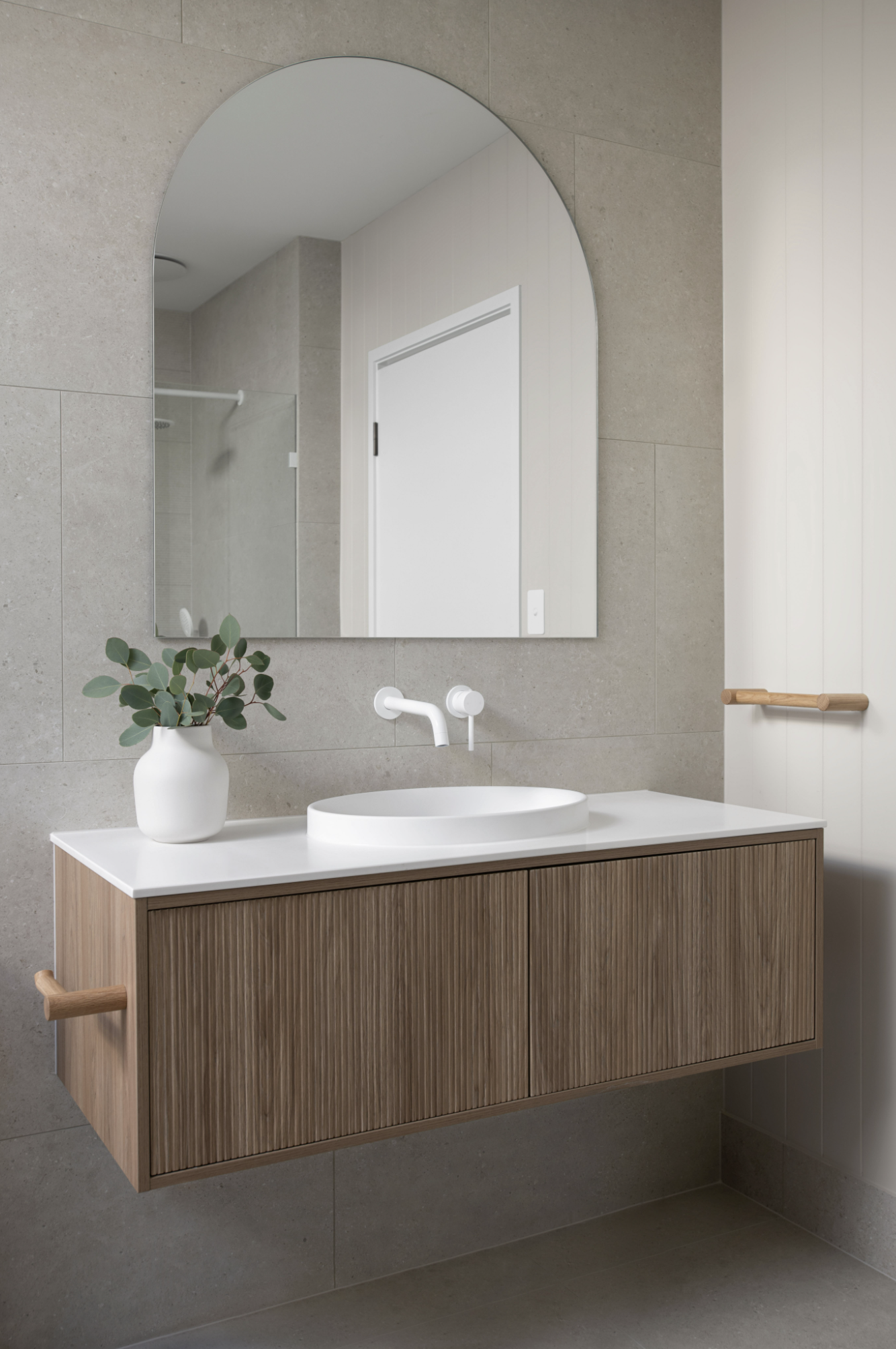 Big bathroom vanity mirror with a floating bathroom basin and wooden cabinets in coral house design bundle for home remodel
