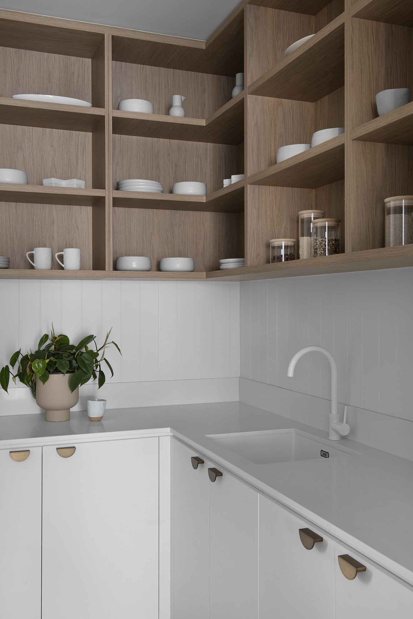 White kitchen counter with multiple wooden shelf in coral house design bundle for home remodel