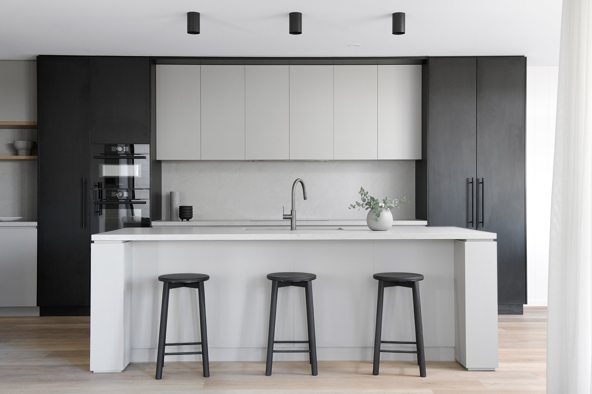 Black stools and a white kitchen counter from Retreat House Kitchen design project included in the kitchen design bundle. kitchen renovation sydneykitchen renovation ideas