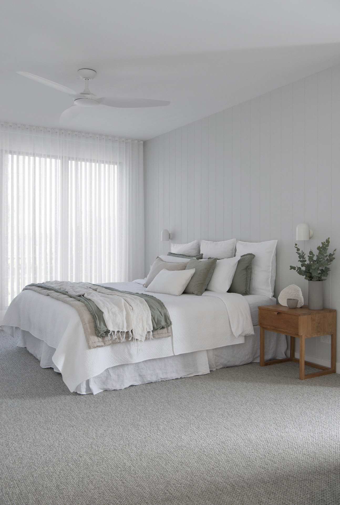 Bed and a grey rug with a wooden side table in classic coastal bed room project included in coastal home design bundle for home remodel