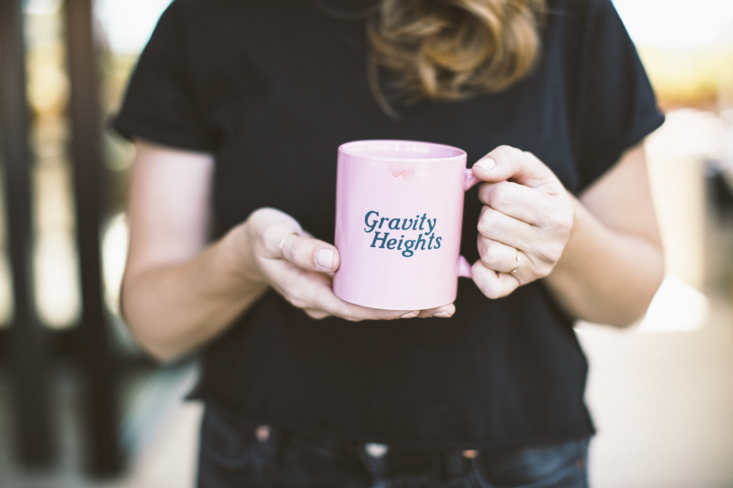 Womann holding pink coffe mug