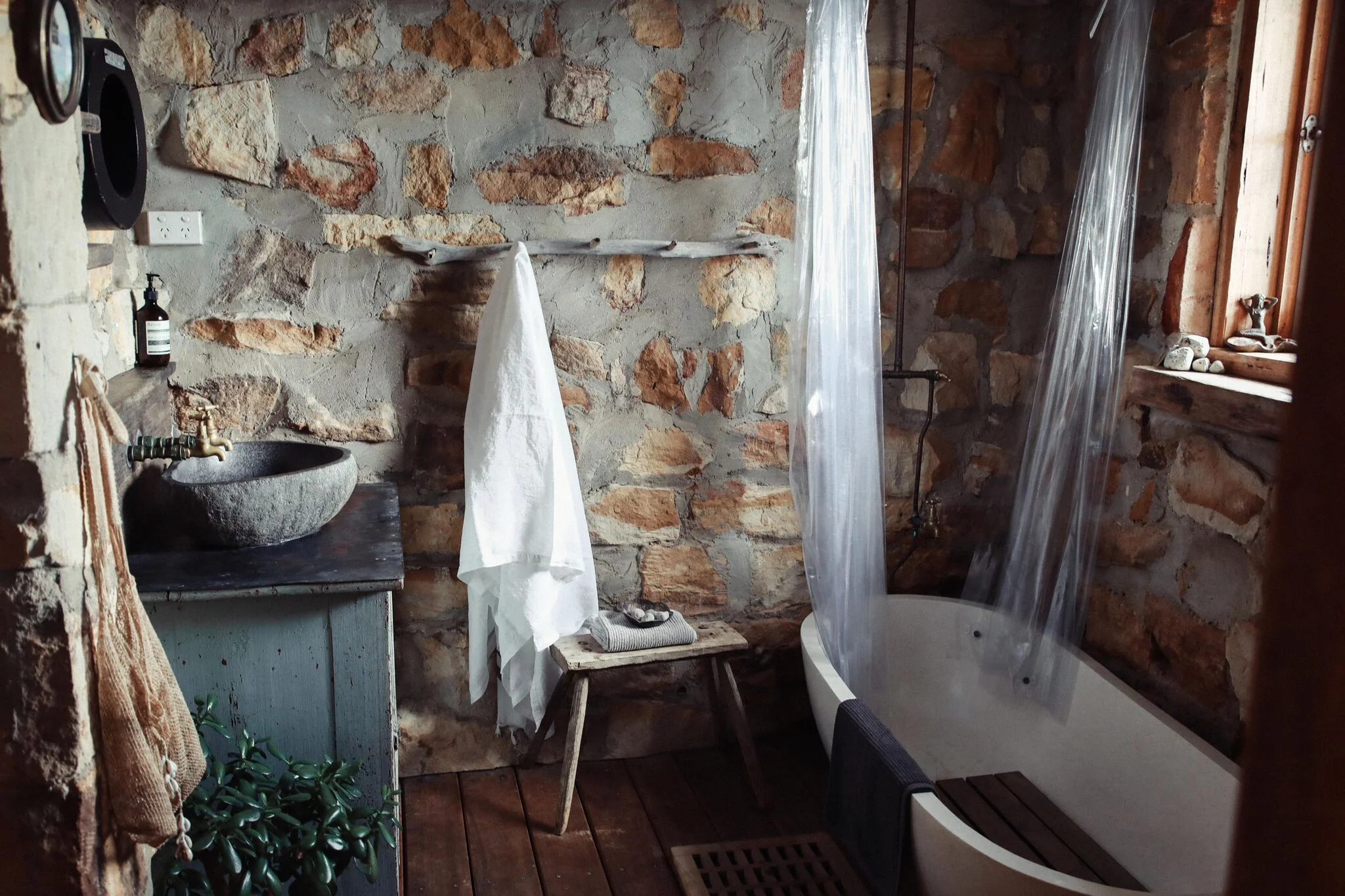 Sandstone and timber bathroom
