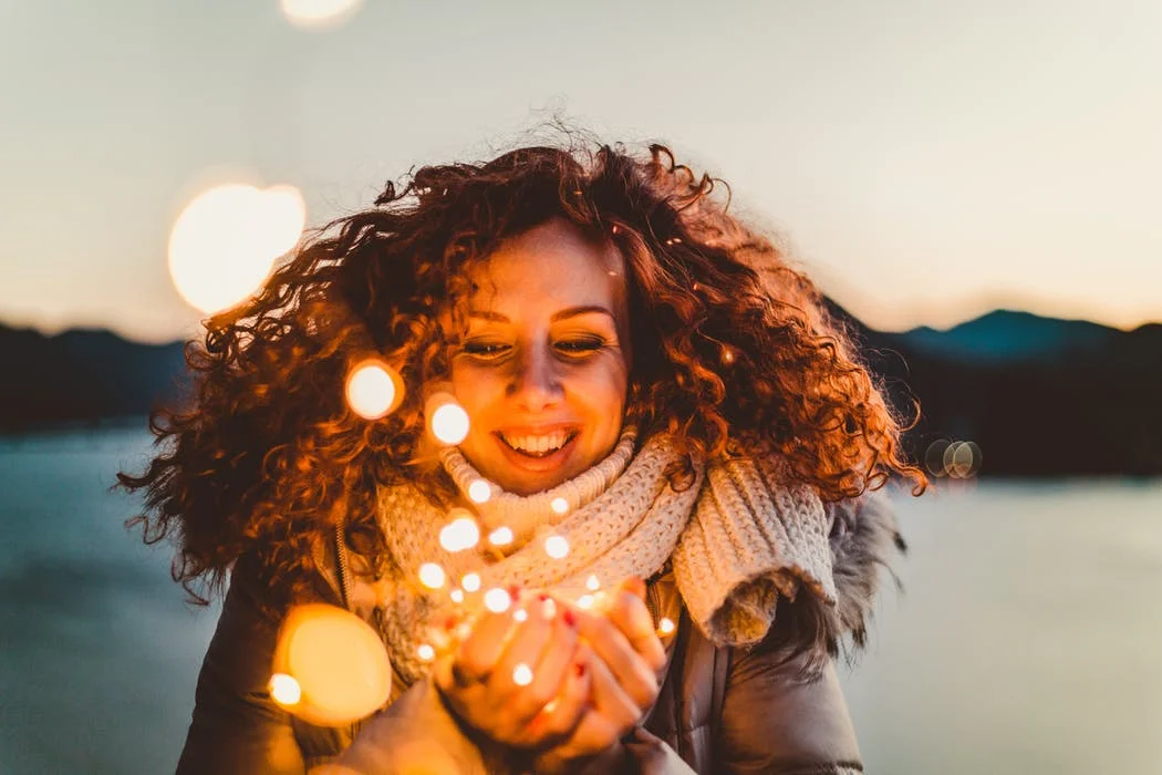 woman lights smiling.jpeg