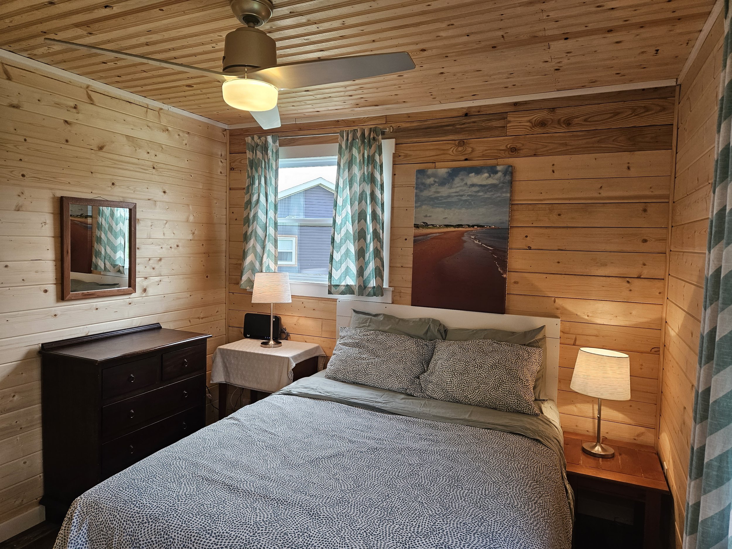 second bedroom- Beachhouse-  new vinyl windows, pine walls, pine ceiling, ceiling fan, new floor, solid 6 panel pine door.jpg