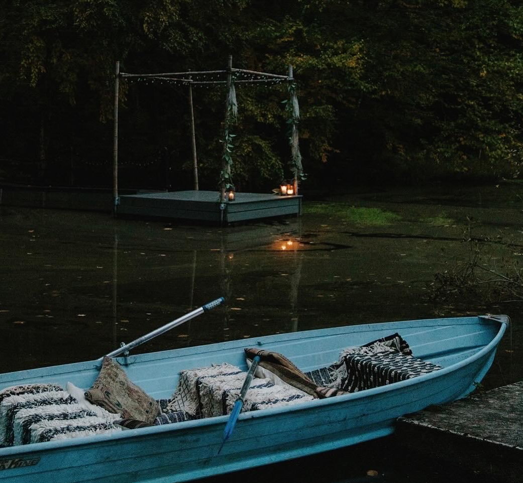 The raft and rowboat in the pond at dusk. It&rsquo;s a happy spring ritual to take the boat out of its winter storage and get it spruced up for a summer of floating under a starry sky or afternoon sunshine.