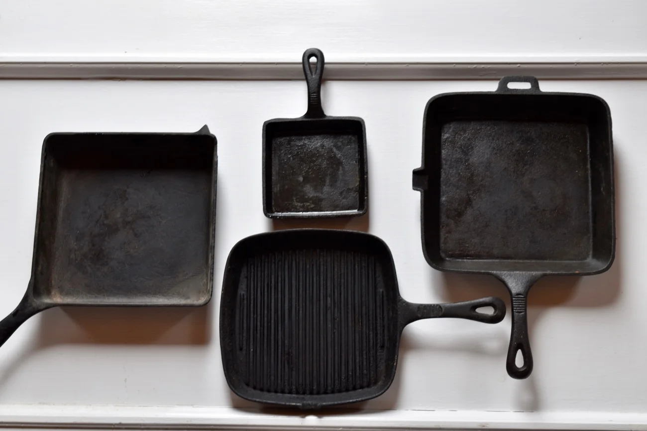 Clockwise from far right: a 9" square pan that's ideal for frying (note the pour spout), ridge grill pan, another 9" square pan that's 2 1/2" deep and ideal for baking; it's "helper handle" is wounded, but the pan works fine. Last but not least, a 5" grilled cheese pan, also good for making square fried eggs for sandwiches.