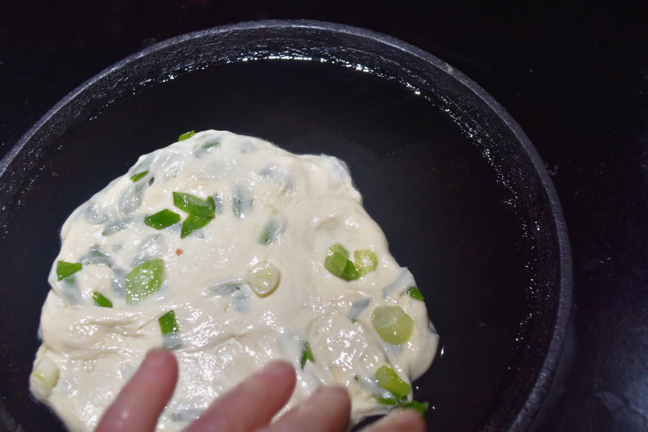 Once the pancake is in the pan you’ll need to tease it into a round shape before it sets.