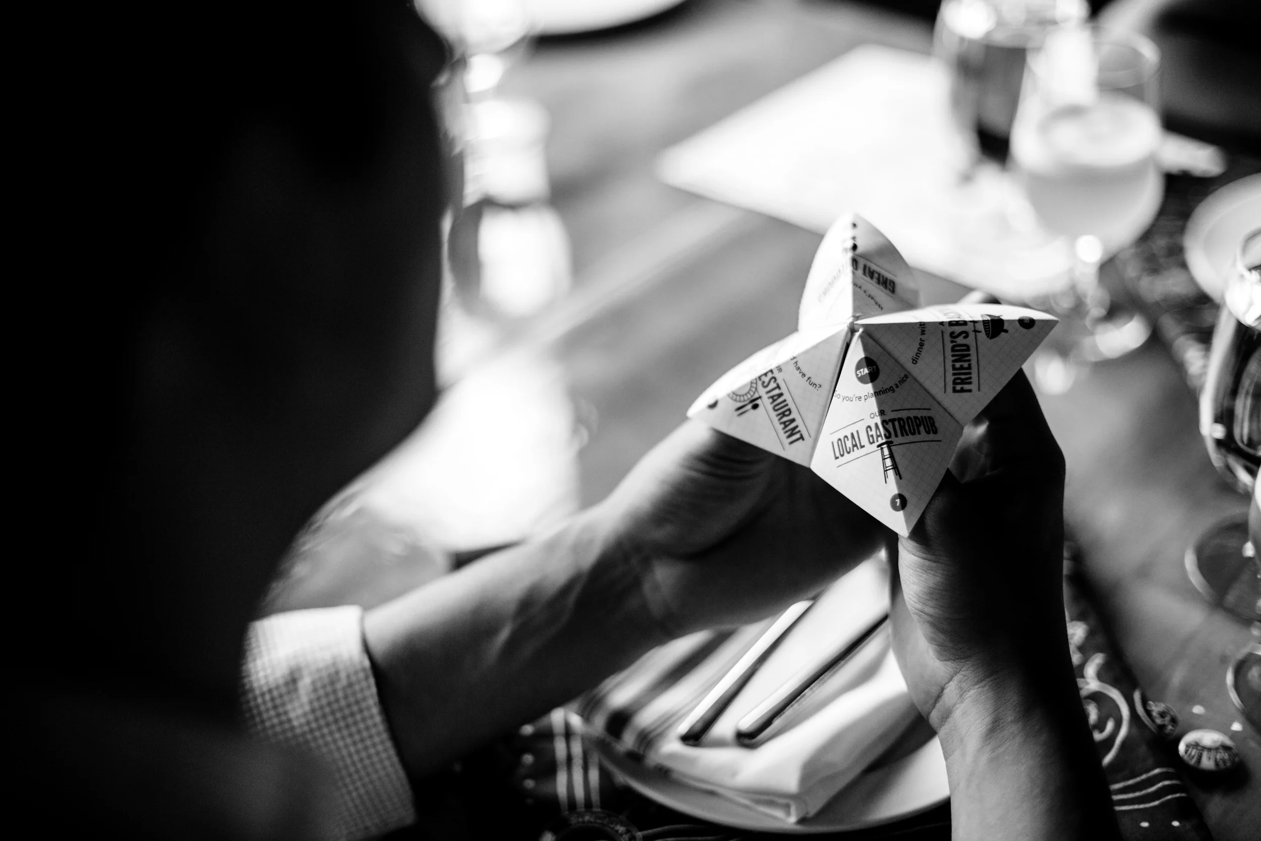 A guest uses the fortune teller beer menu; menu design by Knockout! Studio