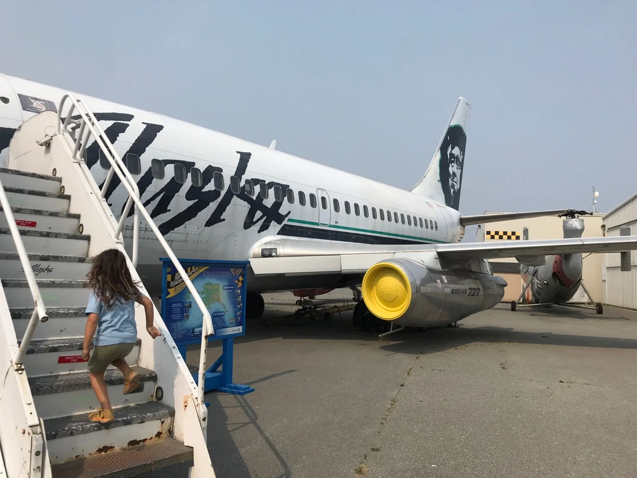 Leo climbing into an old Alaska Airlines 737.