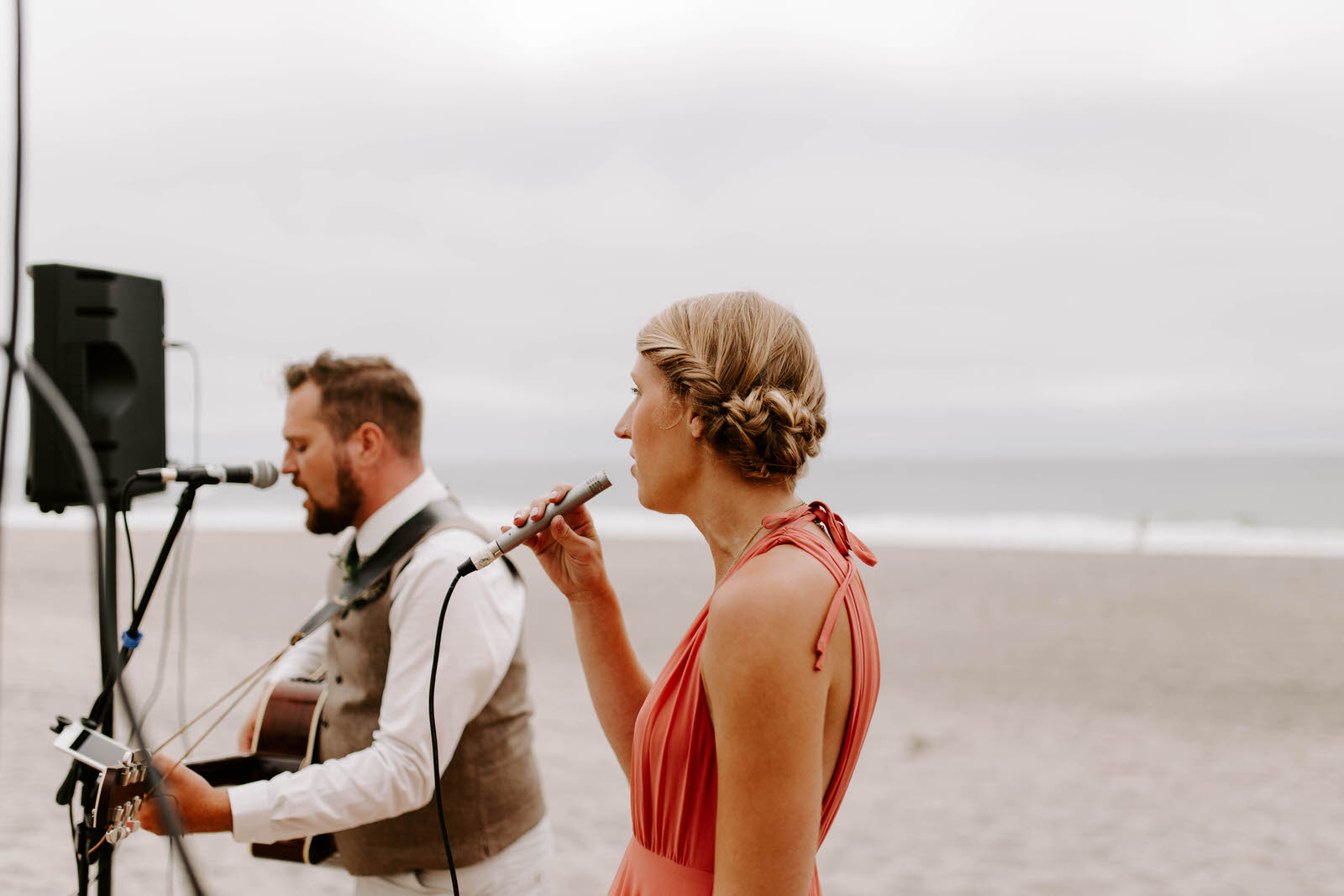pacific city cape kiwanda community center oregon coast wedding beach feminist queer lgbtq photographer jamie carle lgbt overcast sunny harsh sun reception pink bridesmaids dresses