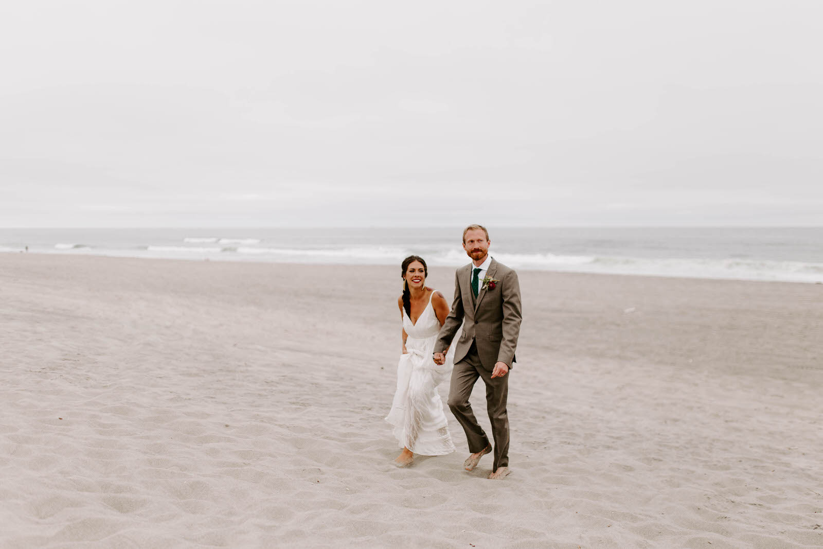 pacific city cape kiwanda community center oregon coast wedding beach feminist queer lgbtq photographer jamie carle lgbt overcast sunny harsh sun reception pink bridesmaids dresses