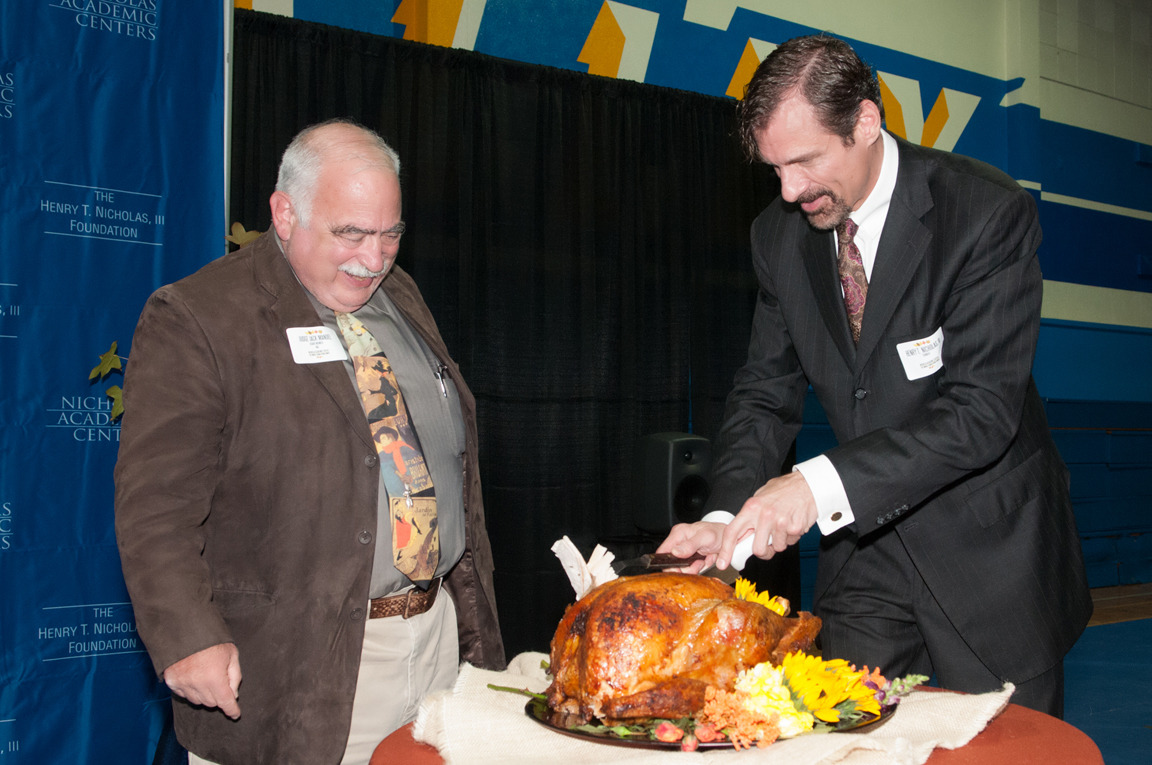 Dr Nicholas, Judge Jack Mandel carve turkey at NAC's 4th Annual Thanksgiving