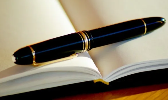 pen-ink-fountain-pen-writing-open-book-pages.jpg