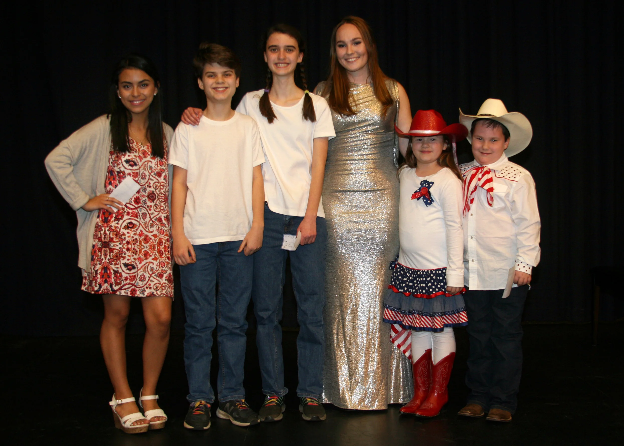 Winners of Sing and Play ’19 were, from left, Jennifer Trejo Benitez of Jordan-Matthews High School, Buck and Maggie Thornton of Chatham Middle School, emcee Sydney Suits, and Jillian and Jack Dixon of Silk Hope School. (Photo by Chip Pate)