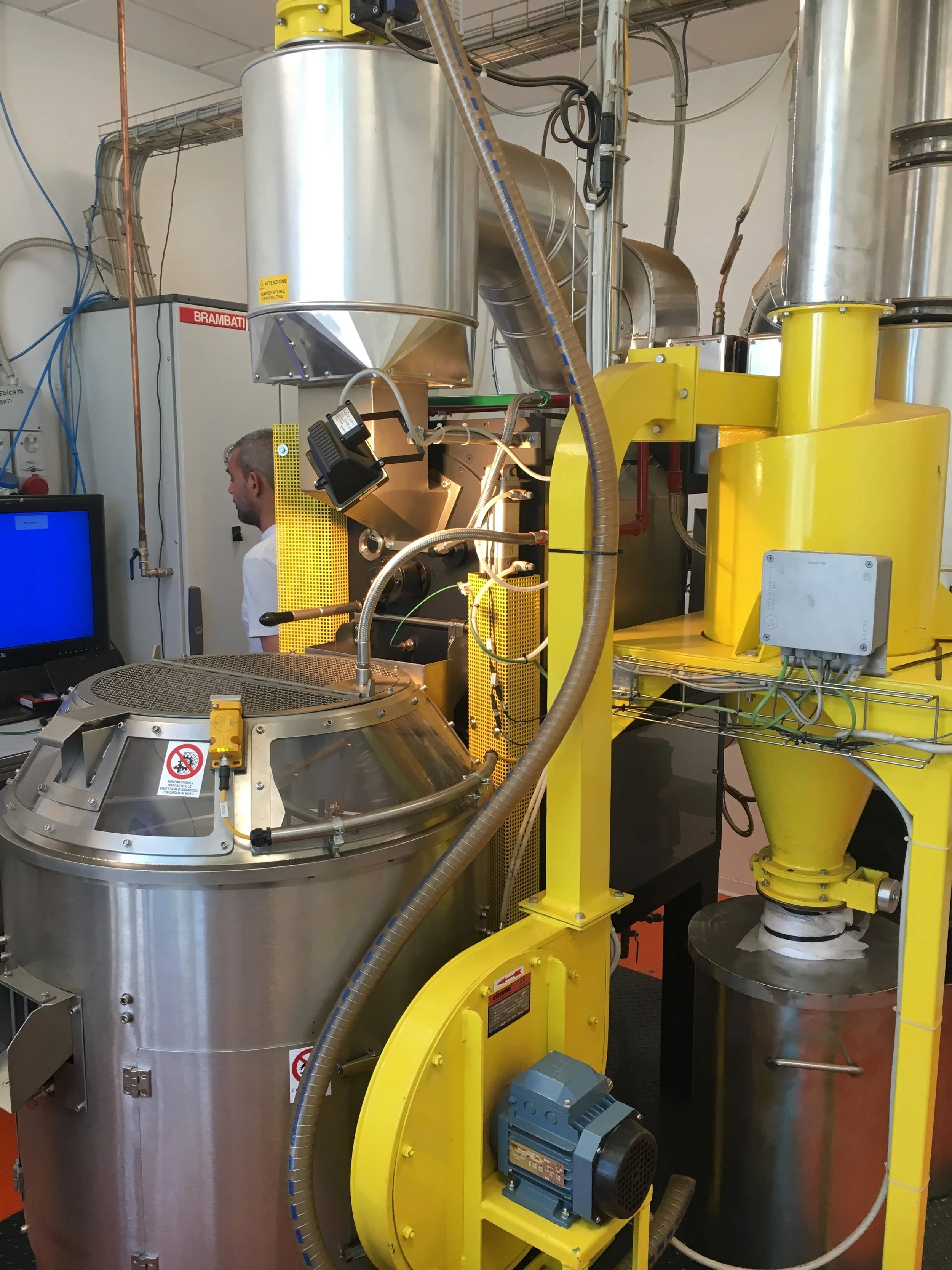 That is, seriously, a 10kg roaster. Note the 7'-tall grey cabinet behind the roaster on the left- that houses the roaster's controls and is itself larger than a typical 10kg roaster.
