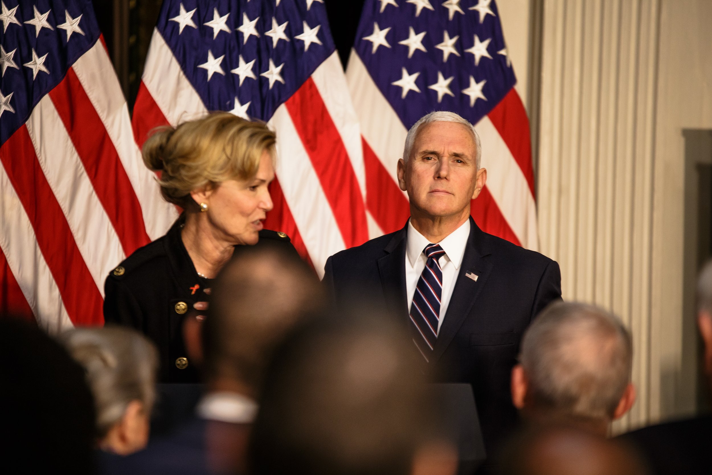  Vice President Mike Pence glances at the press before giving an address on World Aids Day in the Eisenhower Executive Office Building.    November 2018   