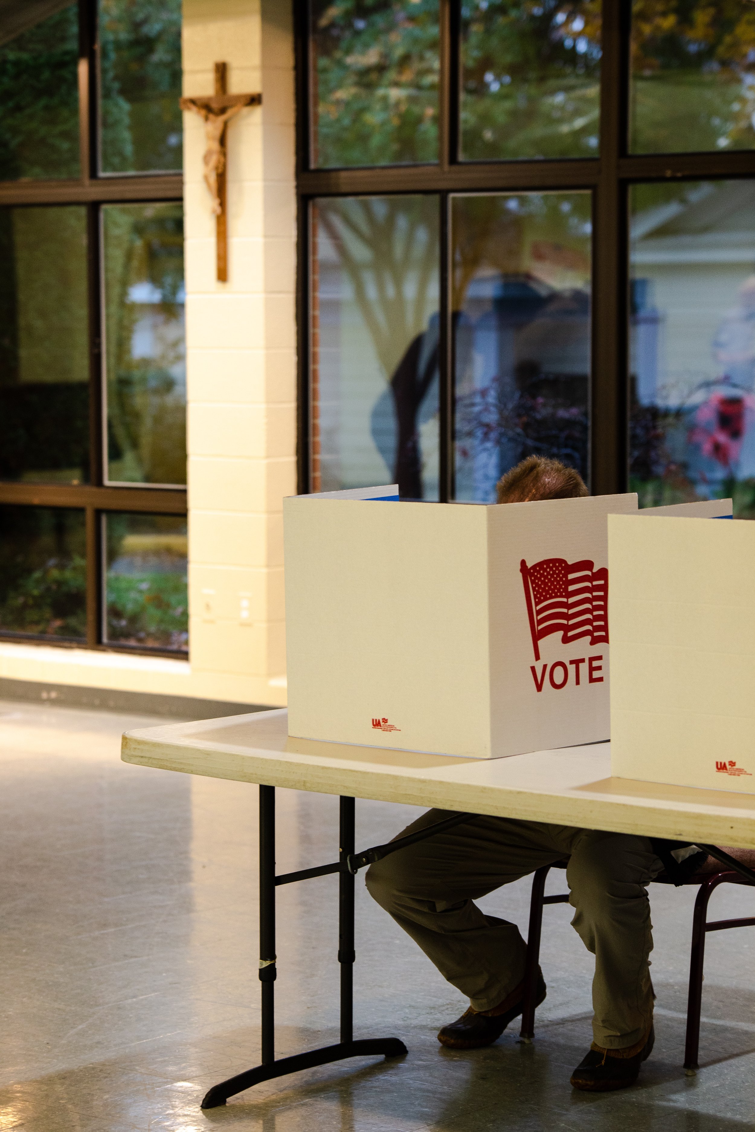  A man casts his ballot under a crucifix during the 2018 midterm elections    November 2018   