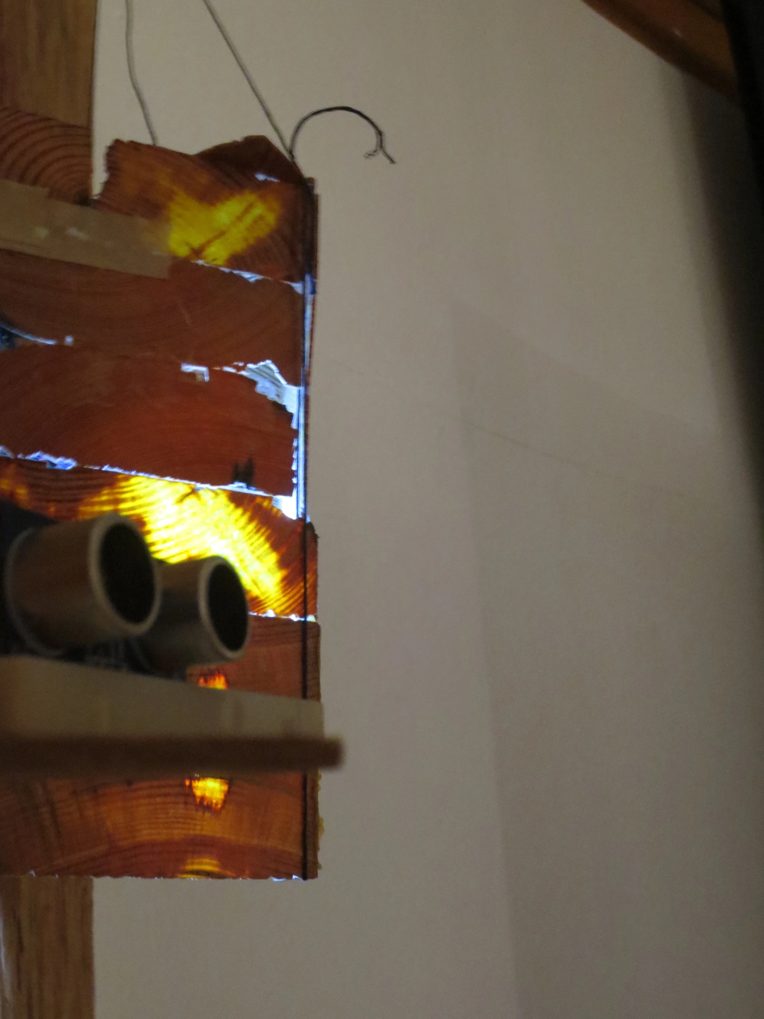 Arduino-controlled sonic sensor that controls light behind wooden lantern.