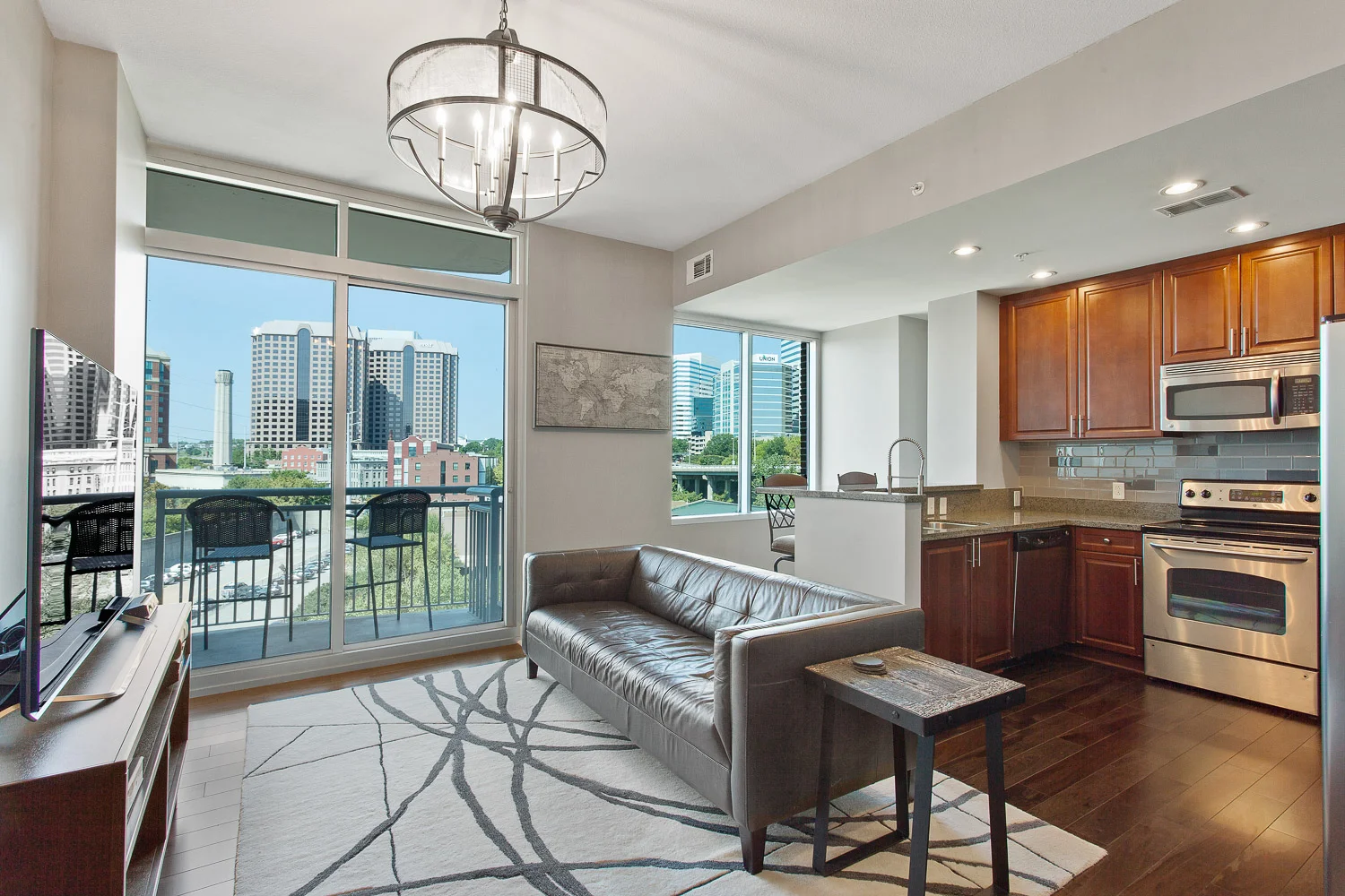 Downtown Condo Living Room and Kitchen with Floor to Ceiling Windows and Balcony of Richmond Virginia City Skyline View