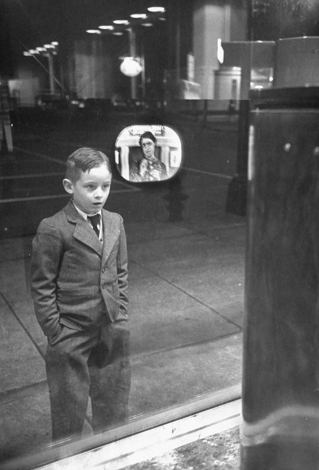 boy-watching-tv-for-the-first-time-in-an-appliance-store-window-1948-2264975642.jpg