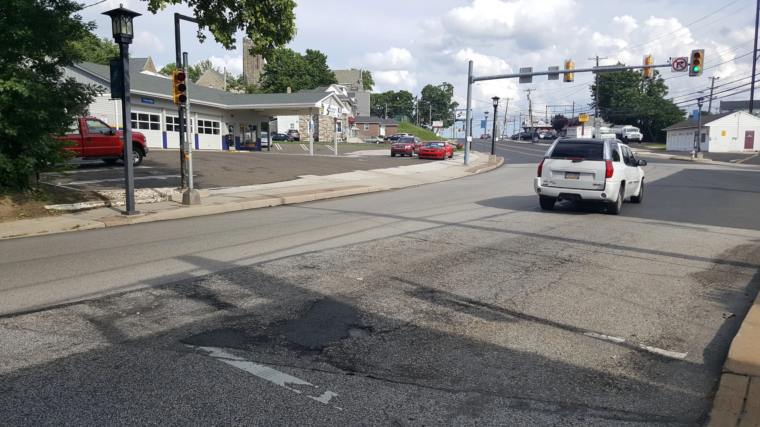 Intersection of Limekiln Pike and Mt Carmel Ave. Pedestrian signal, but no crosswalk.