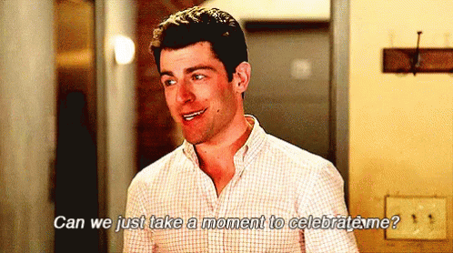 A brown-haired white man wearing a collared shirt and a grin shifts from one foot to the other, turning his head as he asks, "Can we just take a moment to celebrate me?" Gif from https://media.tenor.com/images/dc46ef65b42a7061ea7871cf18147380/tenor.gif