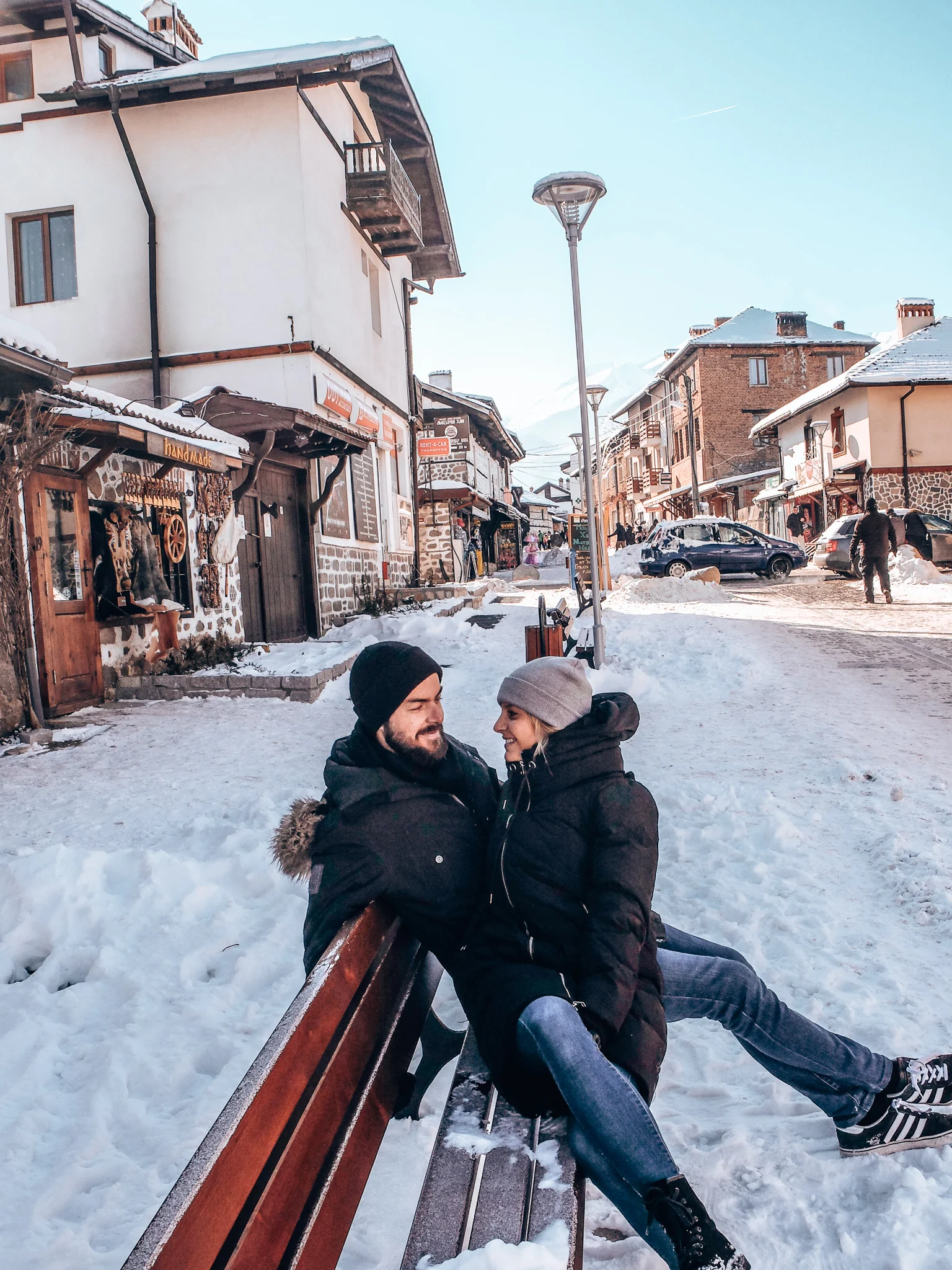Bansko - couple smiling at each other on bench