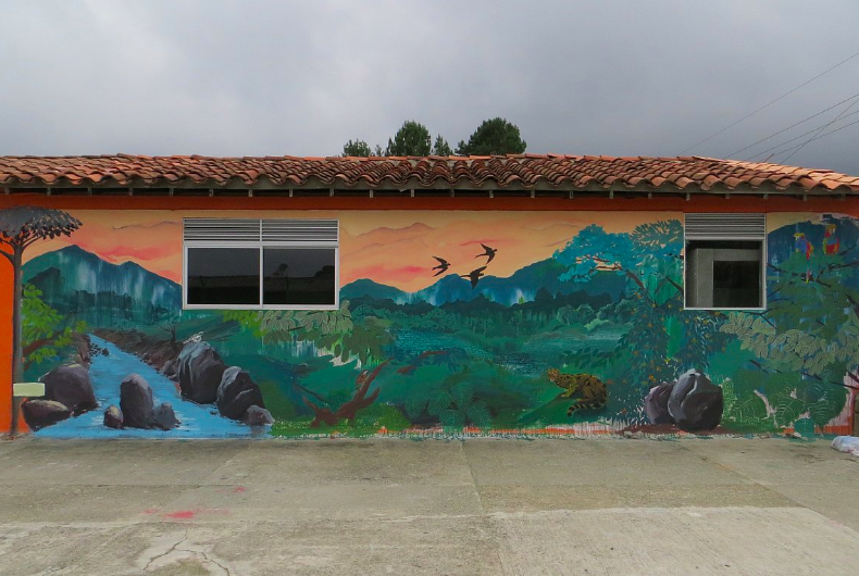 Santa Elena Hermosa, Cuídala. Felipe Ortiz, 2016. (School in Piedra Gorda village, Santa Elena, Colombia) 10' x 42' Acrylic vinyl on wall.