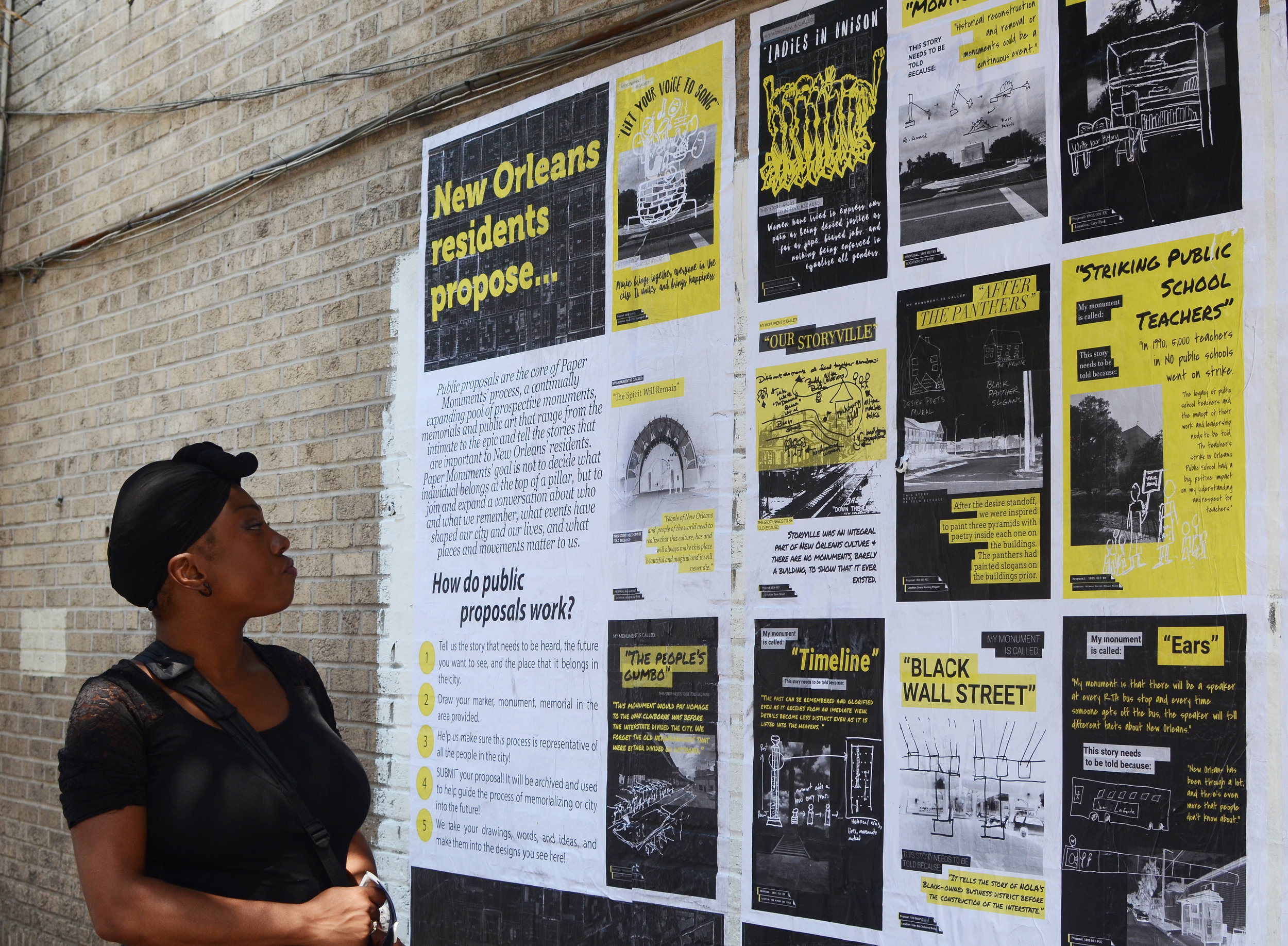  A passer-by reads installation panels detailing the Public Proposal process at the Elk Place site.  