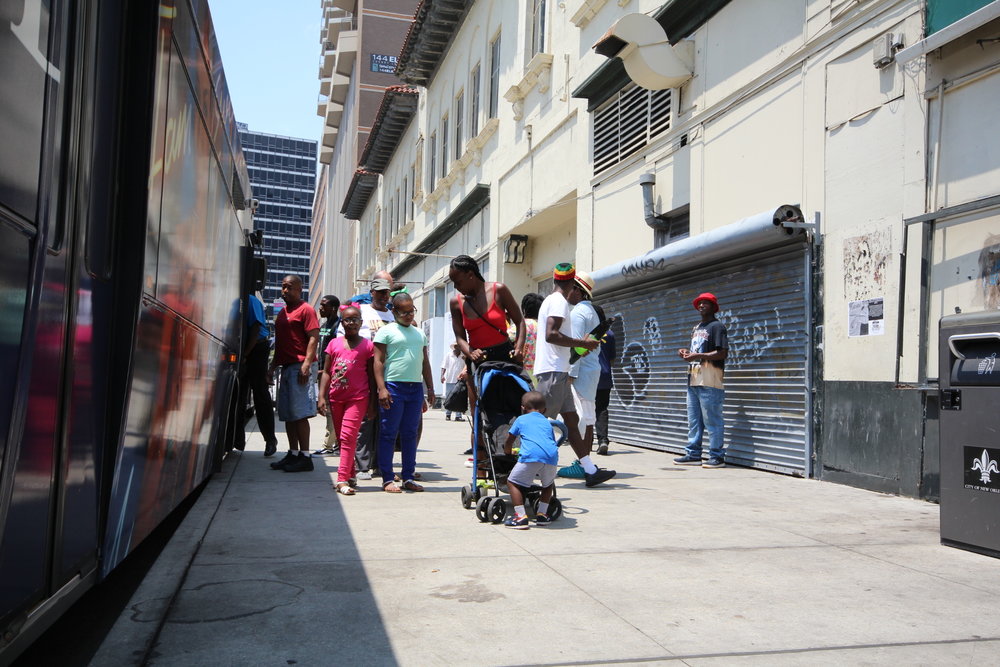  Riders exit a bus adjacent to the Rampart Street site.  
