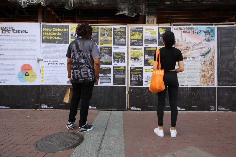  Passers-by read Public Proposal panels at the Canal Street site.  