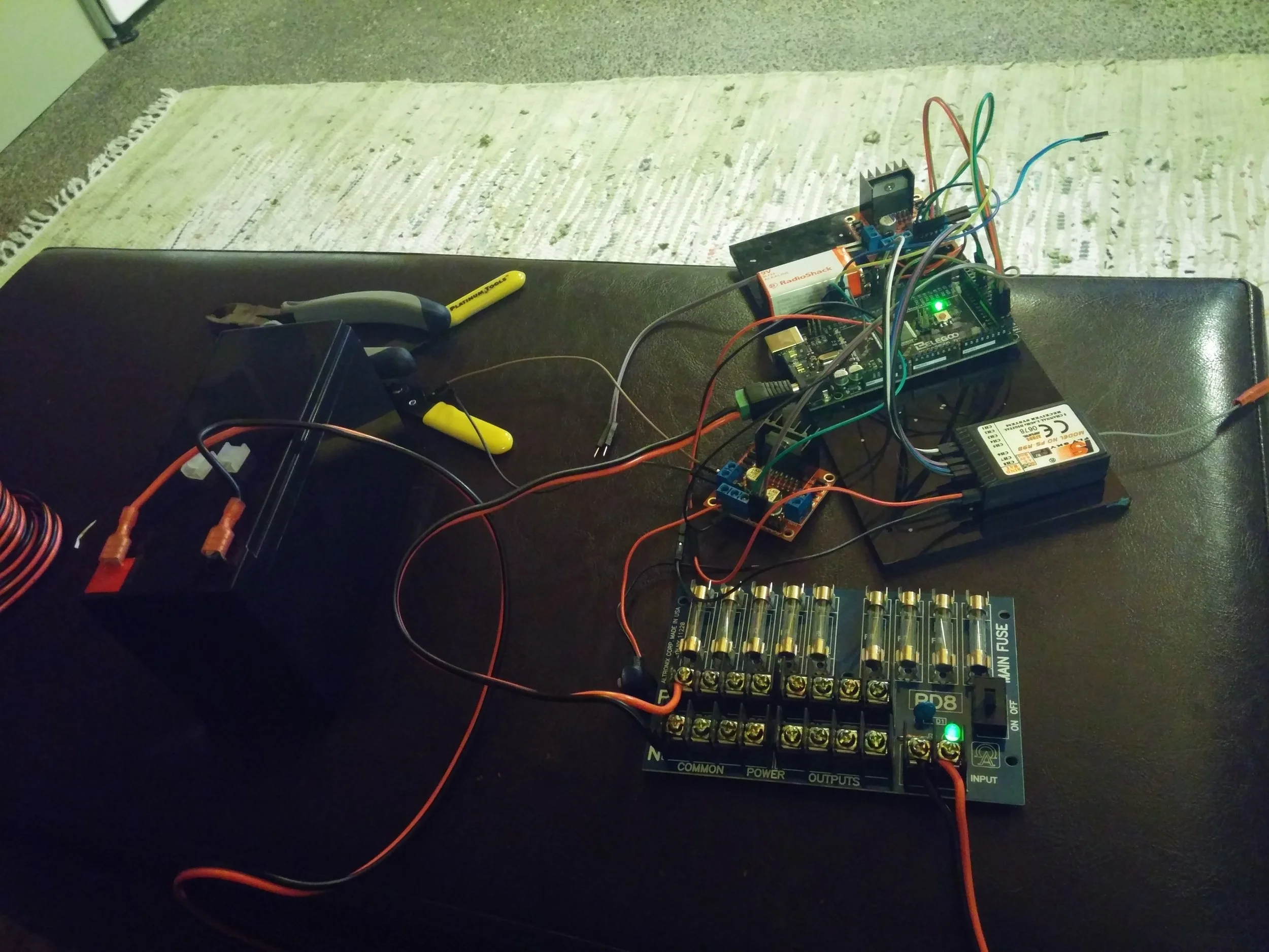 My main task in building this robot was to design the entire control system, from the circuit to the software and everything in between. The heart of the entire system was an Arduino Mega knockoff. I wrote a library to easily and precisely control the DC motors, which all of the winning teams ended up using. You can find it on my GitHub page here . To power the robot we used a big 12V SLA we found cheap on Amazon, which looking back was far more than we needed and added too much weight to the robot. If I could turn the clock back, I would have used an 11.3V LiPo. For the drive motors I used some surplus car seat motors I found on the internet, driven with a pair of BTS7960 motor drivers. These silly little car seat motors stalled at 22 amps (!) and were an absolute blast to work with. The BTS7960 (known also as IBT_2s) drivers were capable of pushing 43 amps, which was absolutely essential for moving our 40 pound robot around the course with the level of agility we wanted.