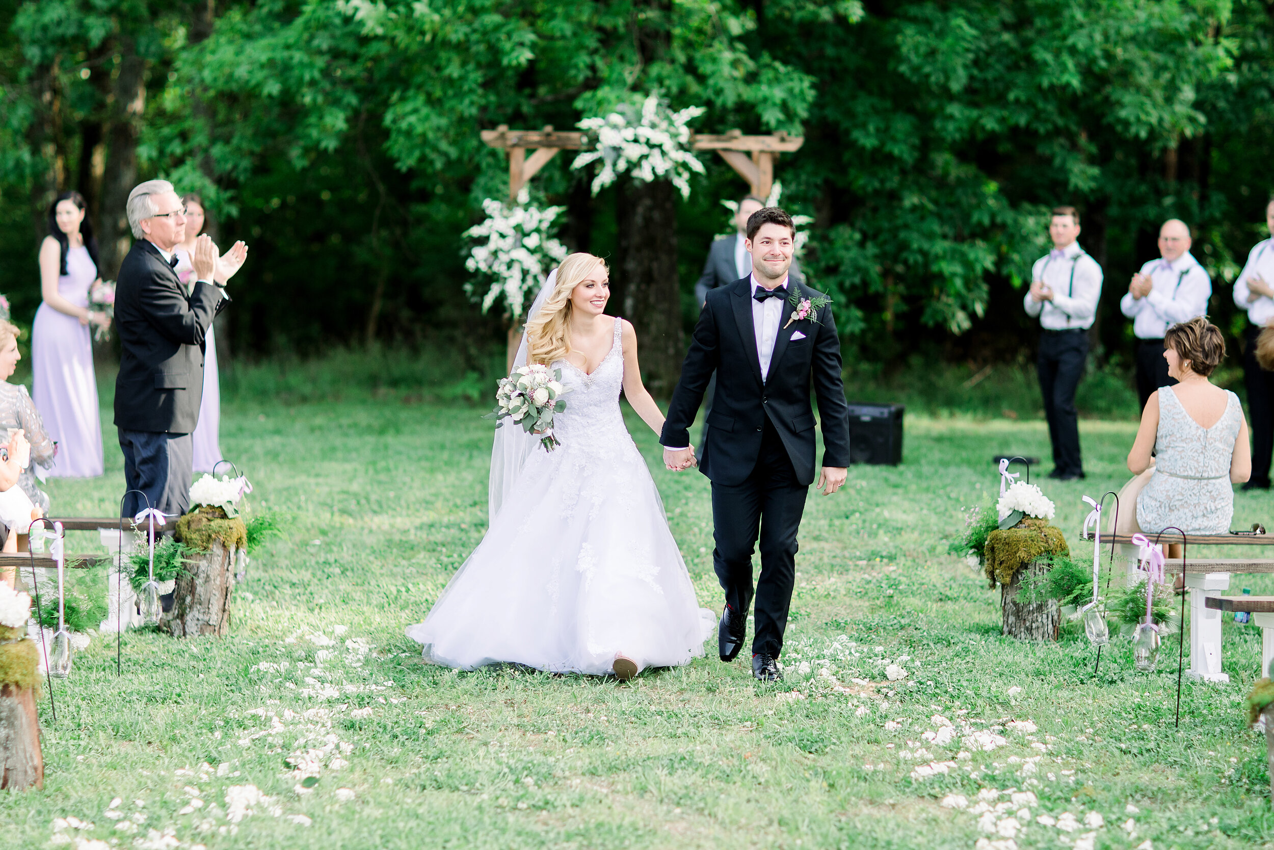 bride and groom walk down aisle together