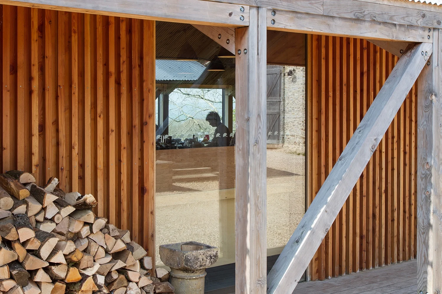 Materials and detailing bond together the new and old elements of the complex. The barn-like structure of the new cookery school exploit the spectacular views and evening sunlight across the rural valley to the west with a crisp fully glazed wall, w