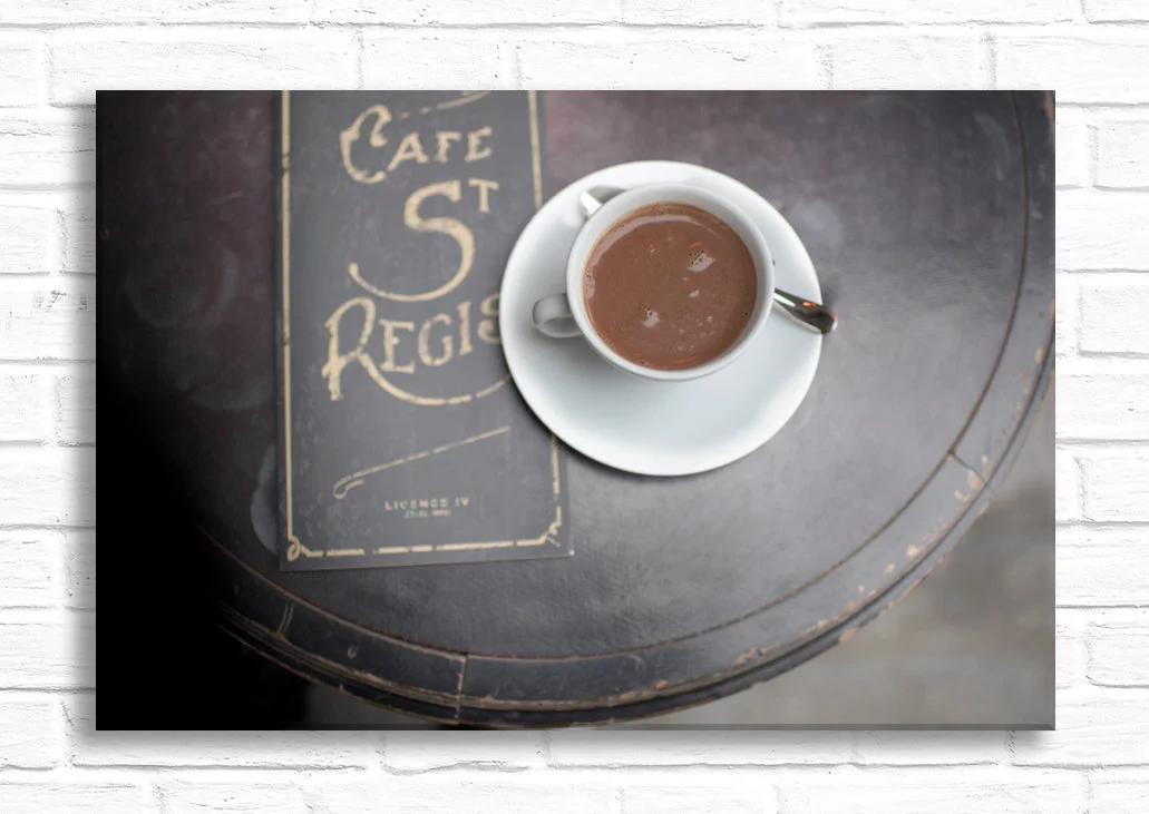 Paris canvas wall art, coffee cup and menu on St. Regis cafe table