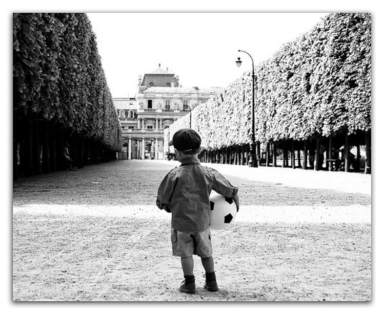 Paris canvas wall art, young boy with football at Palais Royal, black and white