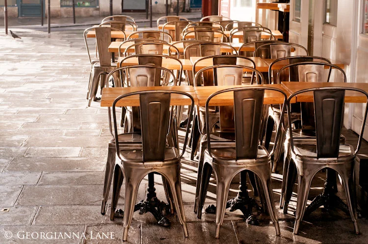 Paris pictures, cafe tables and chairs in street early morning