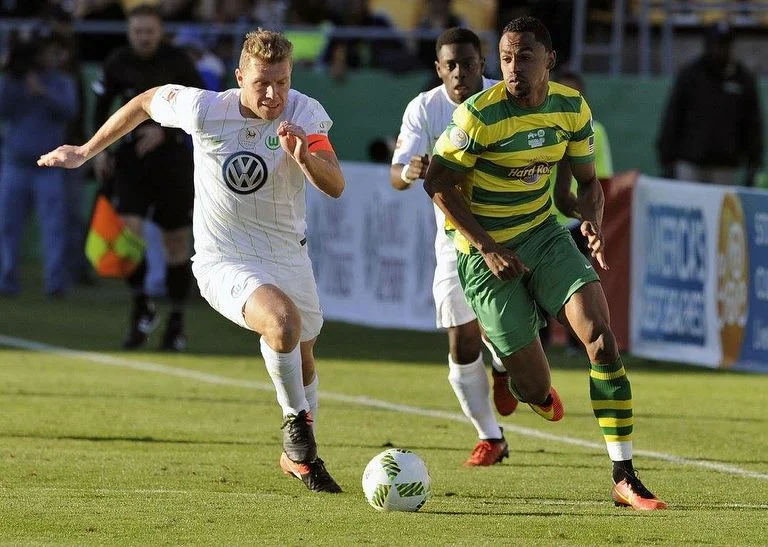 Jonathan Glenn in action against German Bundesliga team Vfl Wolfsburg .