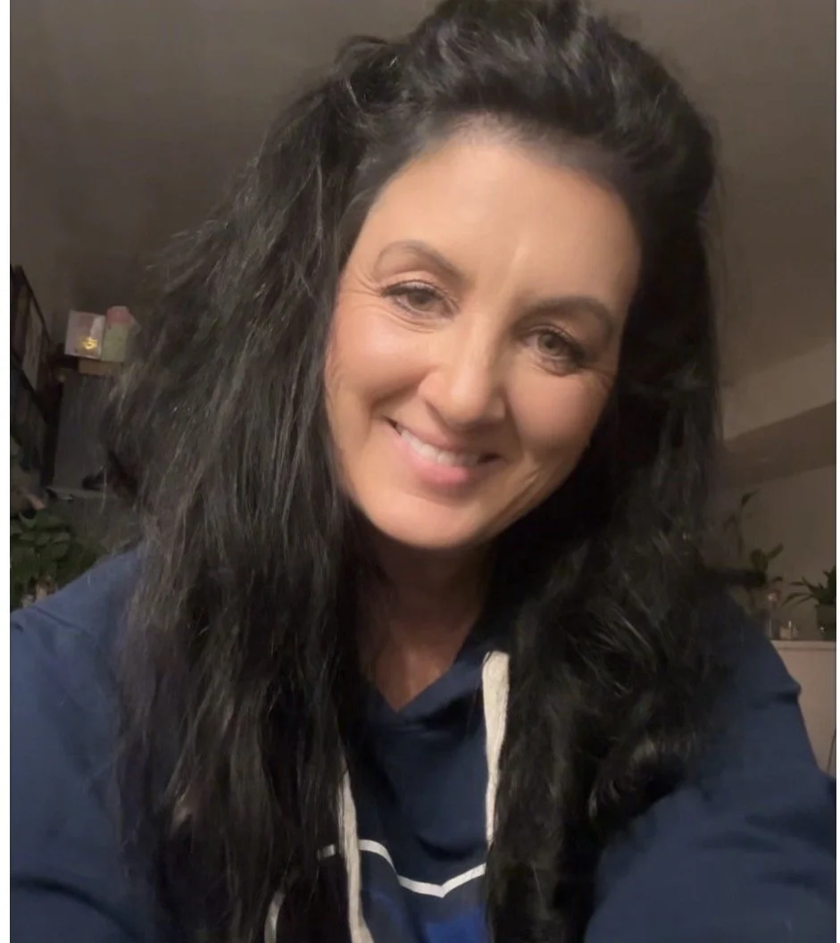 Traci Ainge, founder of Elemental Illumination, smiling.