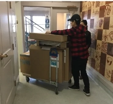Boxes emptied and volunteers Jimmy and Marziya kindly take the boxes down the elevator to the car.