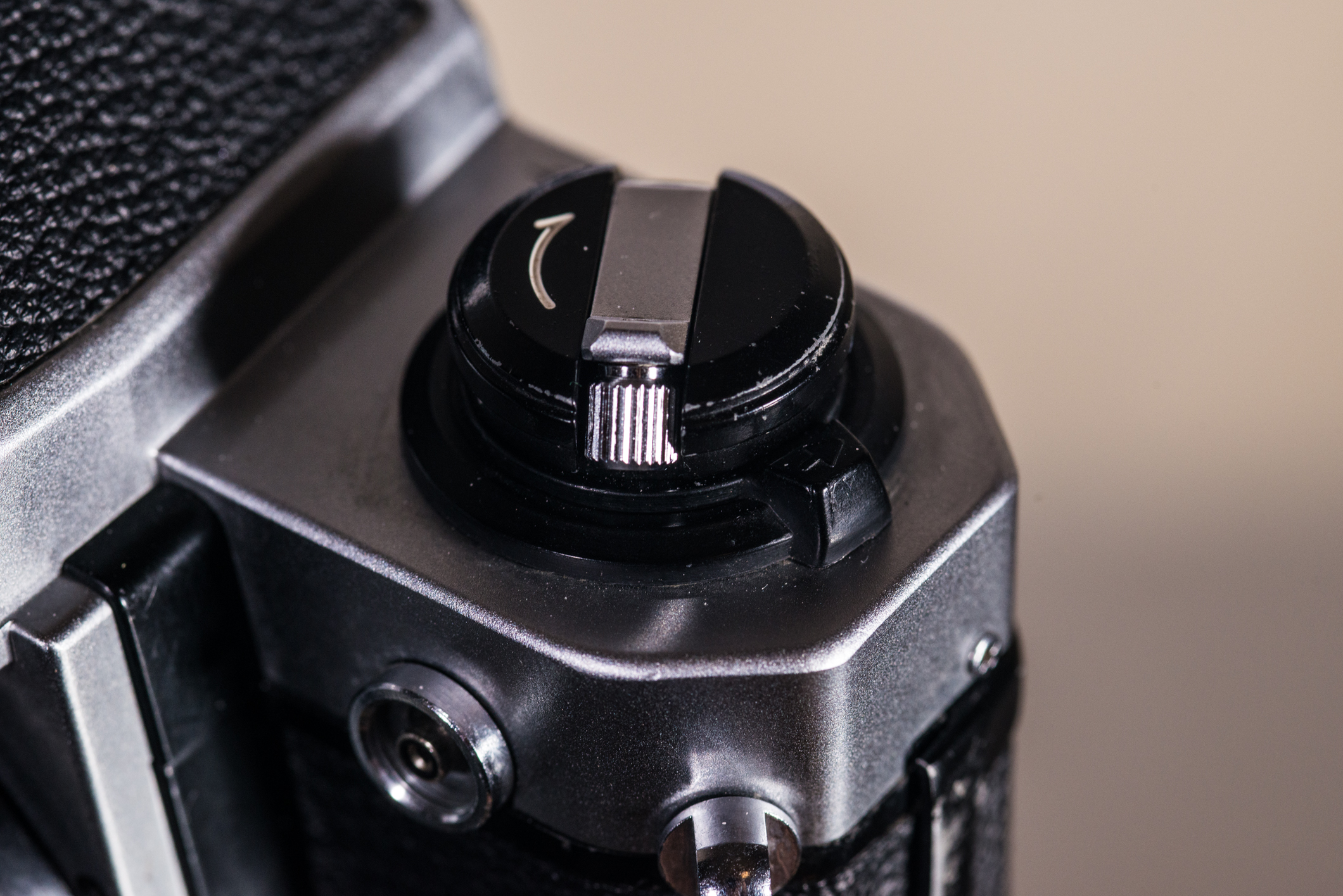 The FM2's plastic lock. This silver rewind lever occasionally flips up on its own.