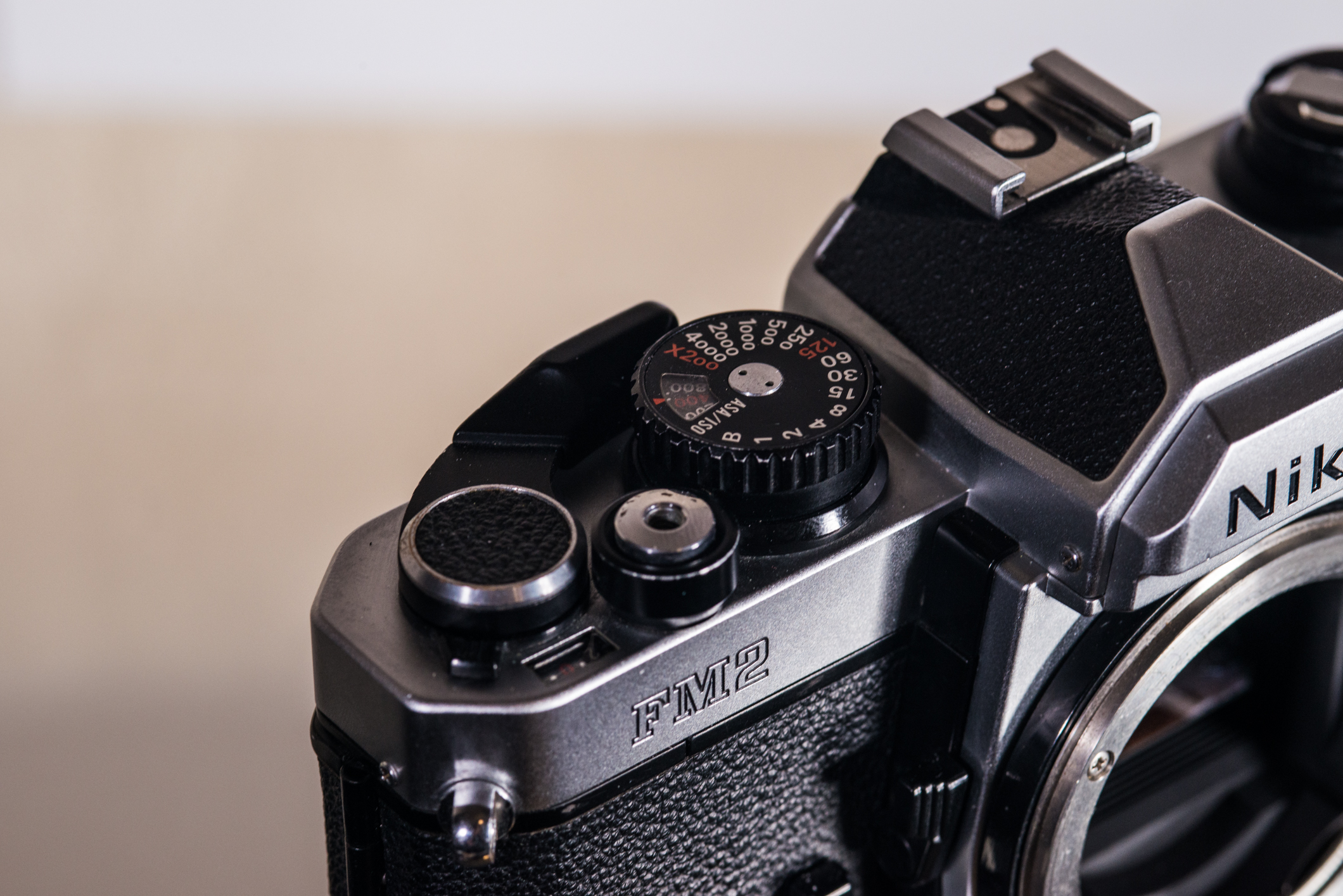 FM2's control area. Note the small tab just off of the advance lever, which stops the film from advancing. This also has a more modern style shutter button and faster flash X-sync speed of 1/200.