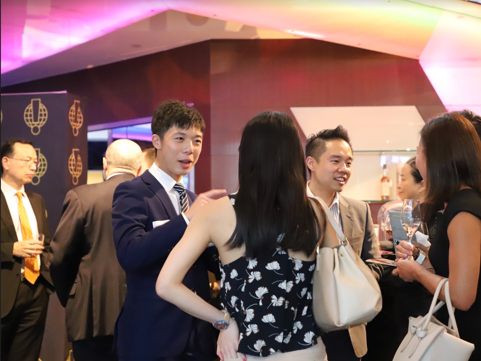 Kim Mak (President, Caritas Institute of Higher Education) in background, Vice President, Conferences and Events Dennis Ling chatting to guests including Malcolm Ong (Head of Product, South China Morning Post)