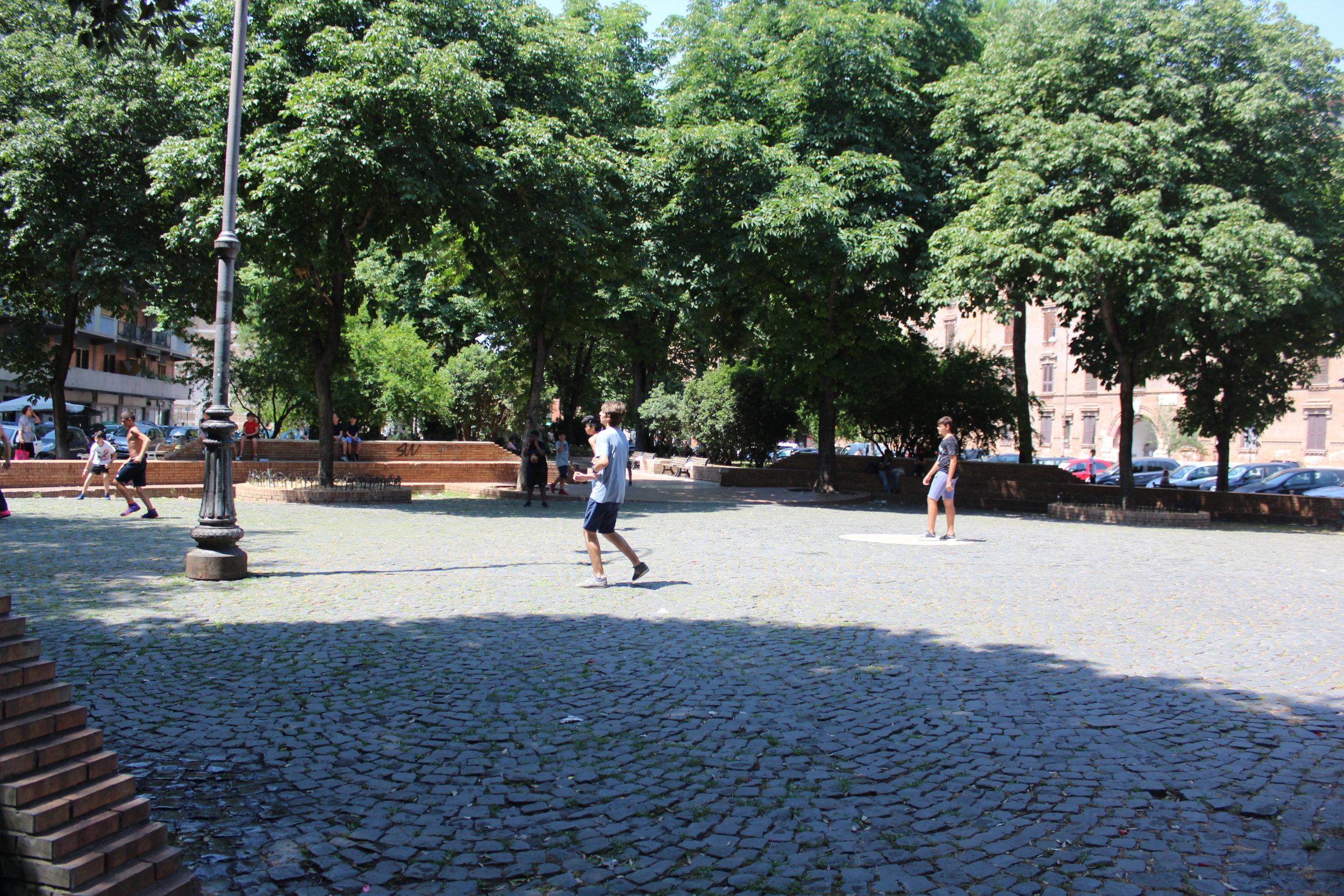 Local kids playing a game of pick-up football.&nbsp;