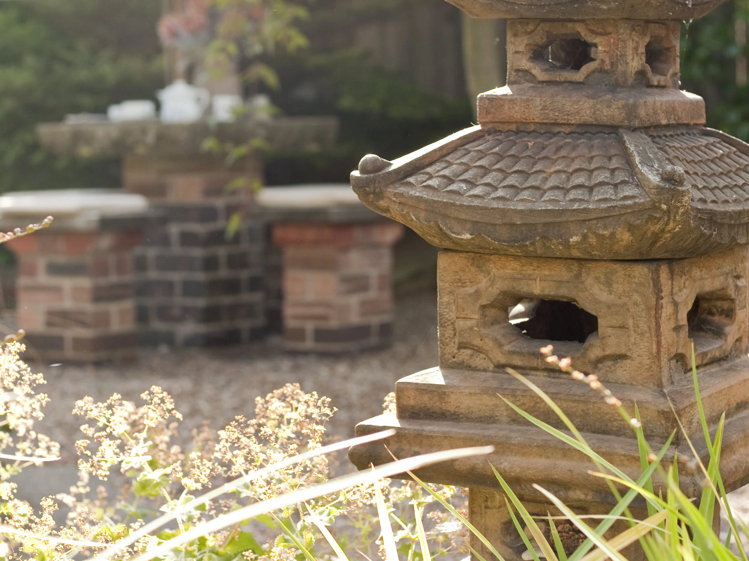 View of garden with large stone ornament