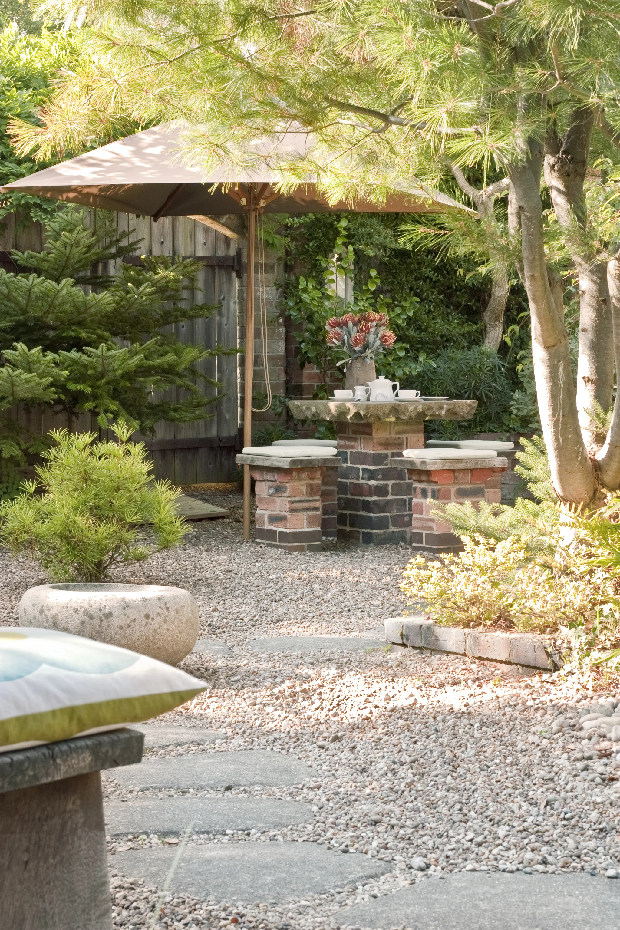 View of garden at the Bottle Kiln with shrubbery, paving, tables and seating