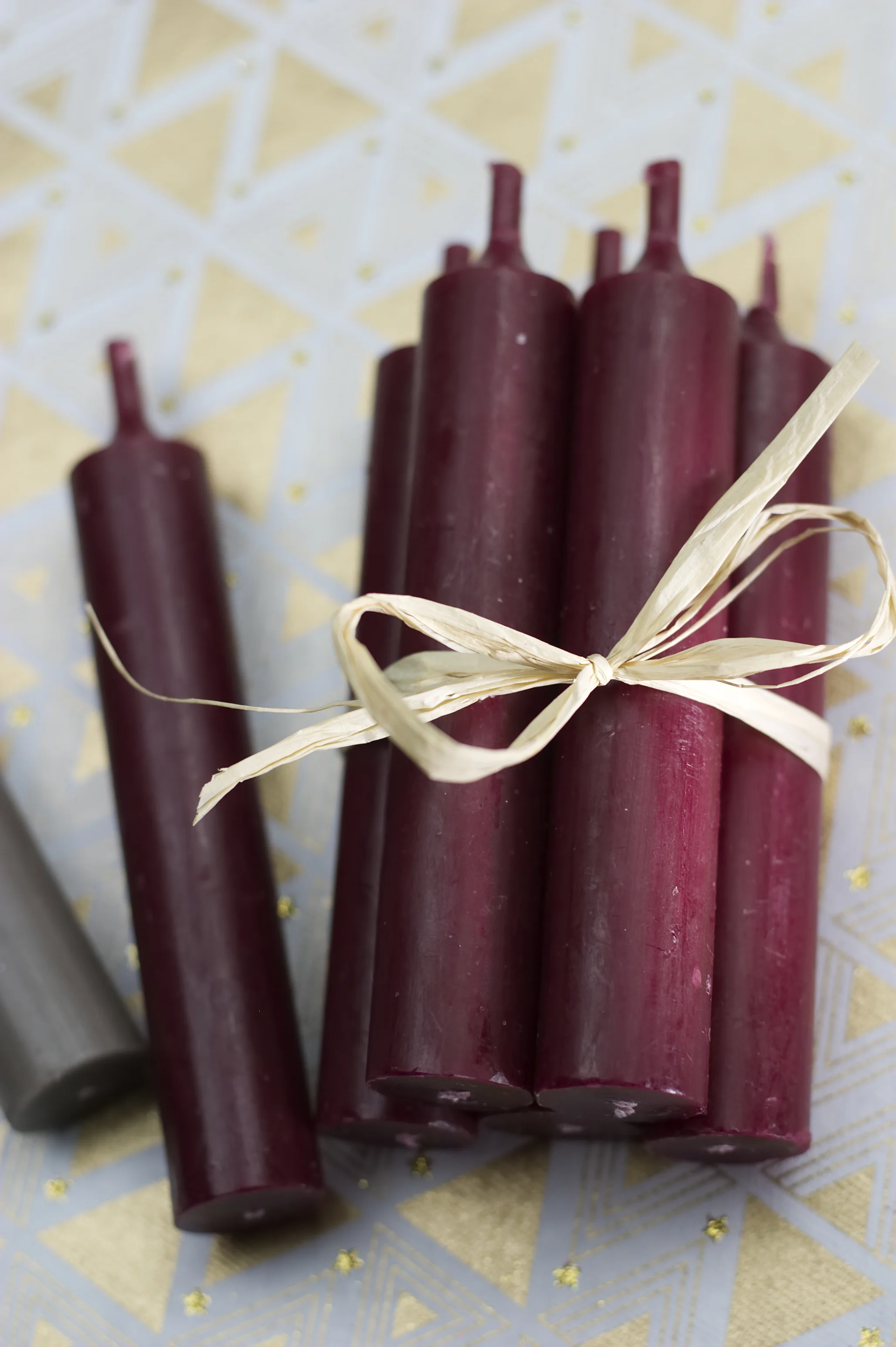 A bundle of several candles wrapped with a bow