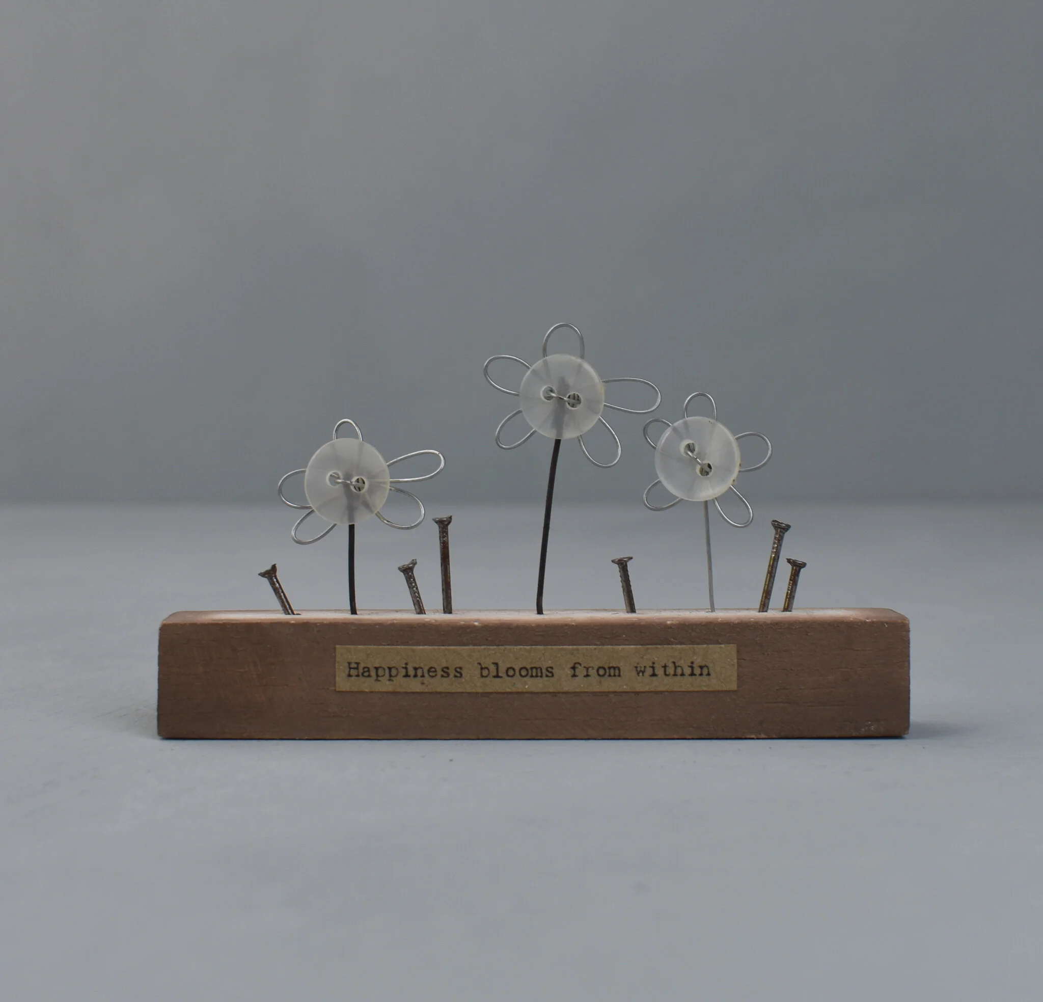 'Happiness blooms from within' wooden block by East of India